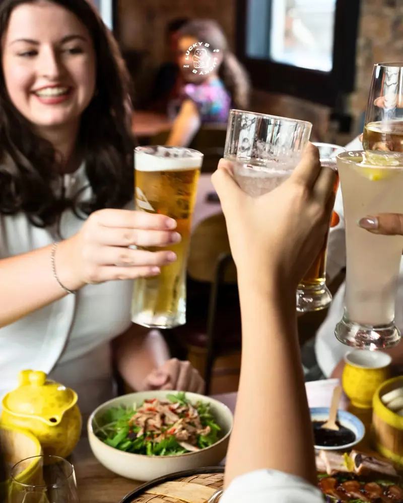 Friends raising a toast over brunch at Lucky 8